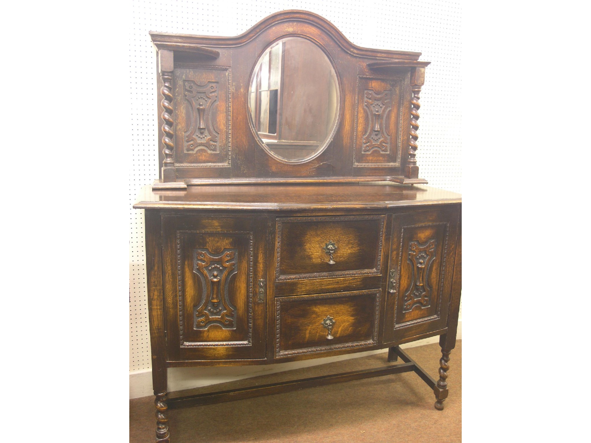 Appraisal: An early th century solid dark oak sideboard oval mirror-back