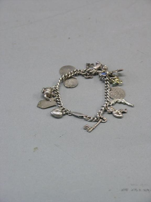 Appraisal: A silver charm bracelet thirteen charms