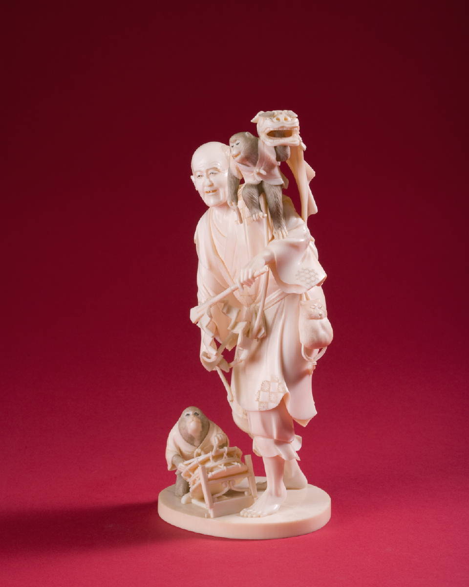 Appraisal: JAPANESE CARVED IVORY FIGURE OF A MAN WITH MONKEYS AND