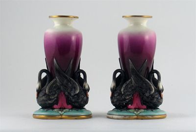 Appraisal: An unusual pair of Royal Worcester vases each supported on