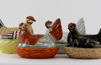 Appraisal: Four Staffordshire models of chickens on baskets variously glazed and