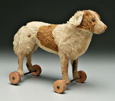 Appraisal: Mohair dog pull toy mounted on four wooden wheels late