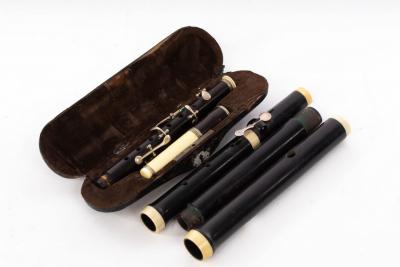 Appraisal: An ebony flute by Gebr Schott Mainz with ivory bands