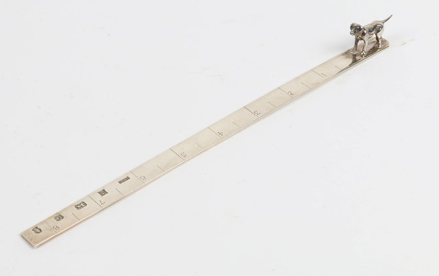 Appraisal: A SILVER DESK RULER measuring inches and mounted with a