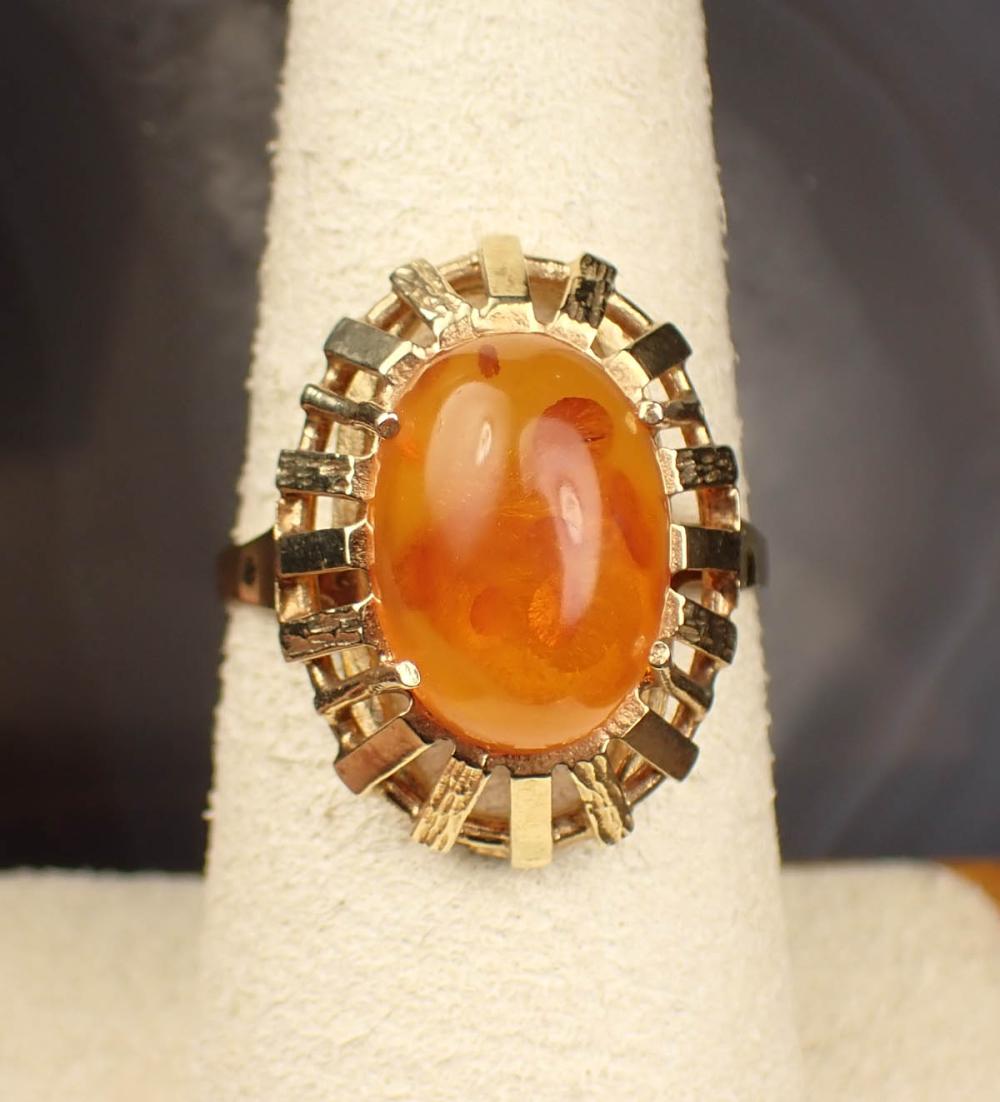 Appraisal: AMBER AND FOURTEEN KARAT GOLD RING The yellow gold ring