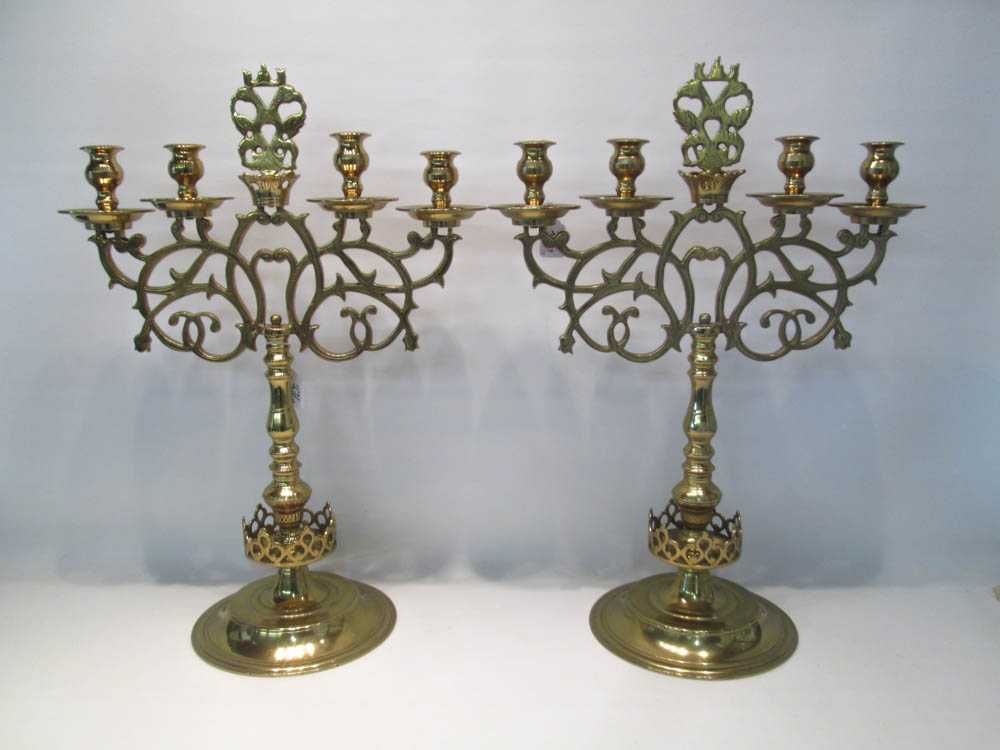 Appraisal: PAIR OF BRASS CANDELABRA with four lights and armorial crest