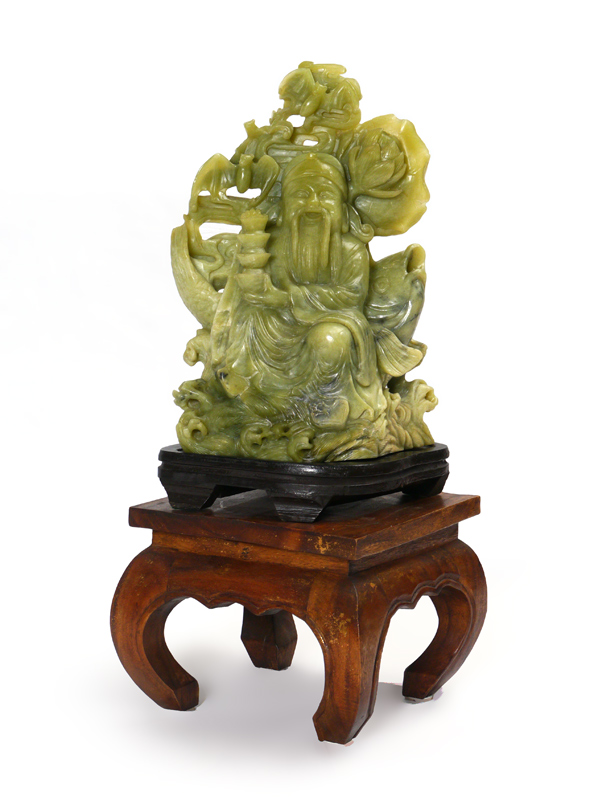 Appraisal: DECORATIVE CARVED SEATED BUDDHA ON STAND Composite green stone happy