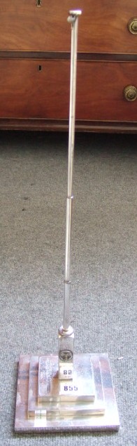 Appraisal: A plated desk flag pole on a stepped square base