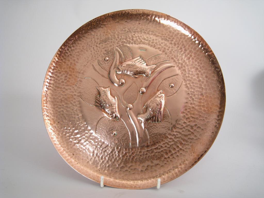 Appraisal: A Newlyn copper Charger embossed three fish and bubbles within