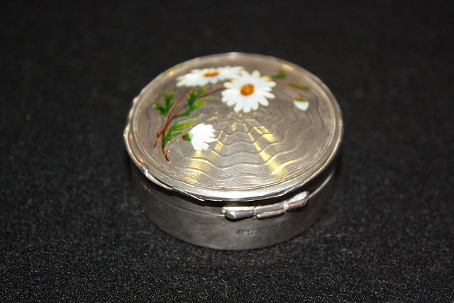 Appraisal: A SMALL SILVER CIRCULAR PILL BOX with inset enamel flowers