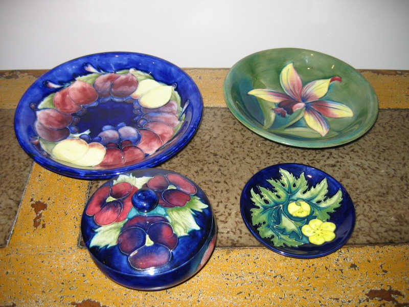 Appraisal: MOORCROFT ENGLAND Four pieces lidded bowl h two plates d