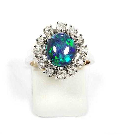 Appraisal: OPAL AND BRILLIANT-CUT DIAMOND RING White gold Decorative ring set