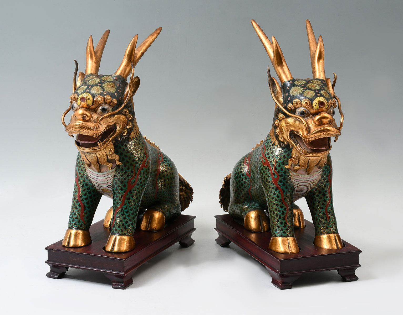 Appraisal: PAIR OF CHINESE CLOISONNE QILIN STATUES Qing dynasty Gilt copper