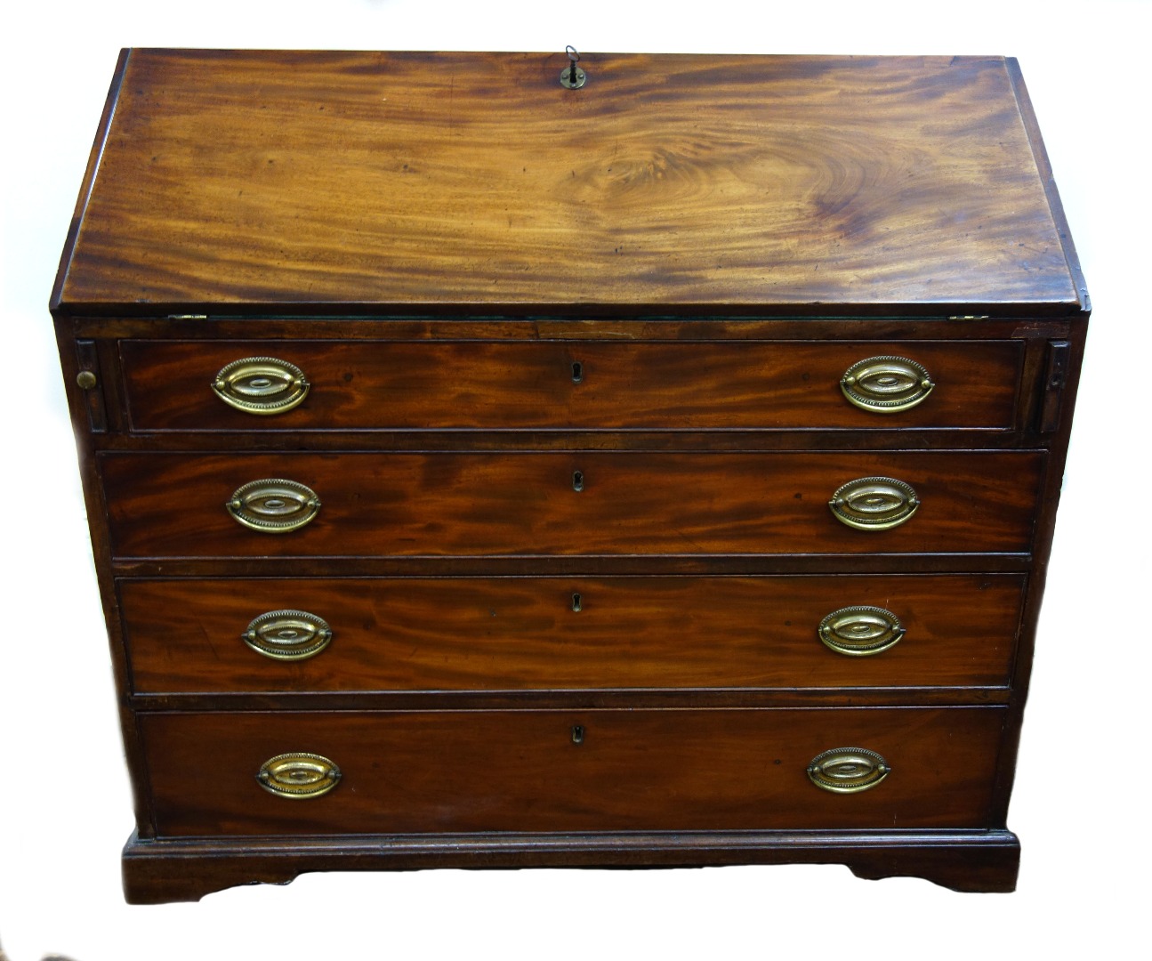 Appraisal: A George III mahogany bureau the hinged fall enclosing a