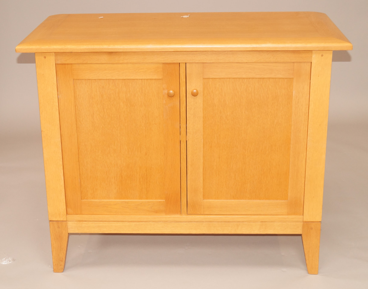 Appraisal: A light oak side cabinet with two panelled doors on