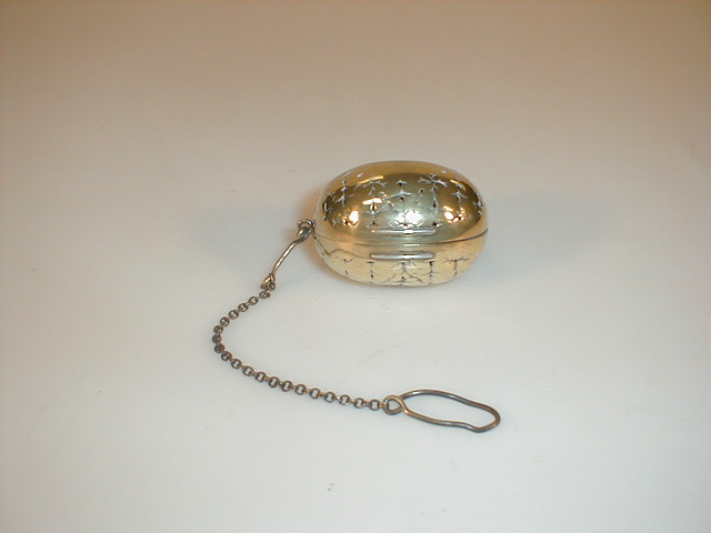 Appraisal: A Victorian silver gilt tea infuser the ovoid pierced body