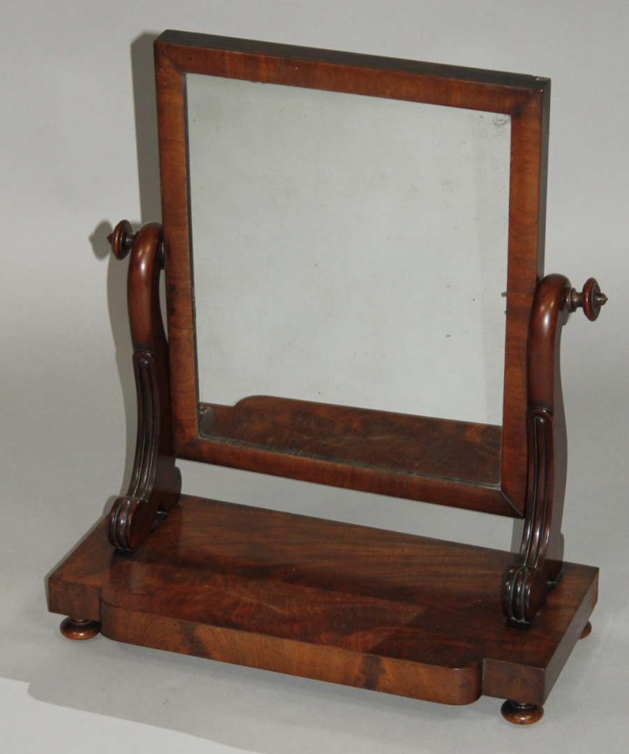 Appraisal: A thC flame mahogany table mirror the rectangular glass flanked