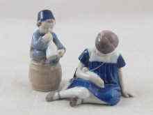 Appraisal: Two Royal Copenhagen ceramic figures a young girl carrying a