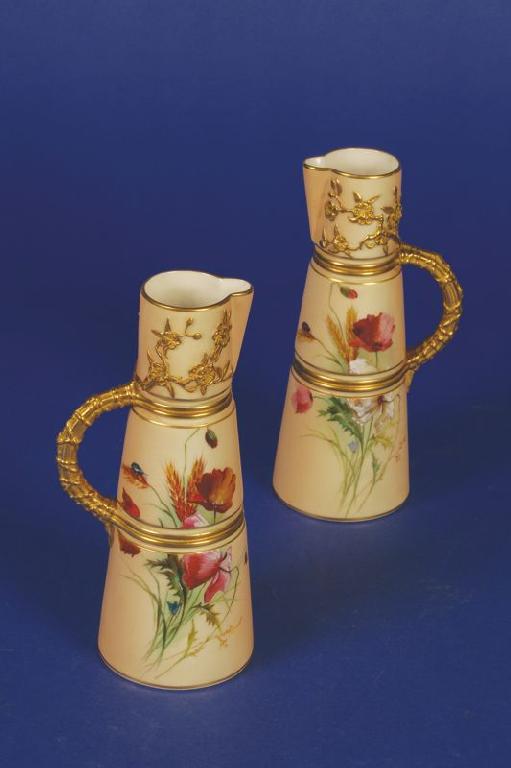 Appraisal: A PAIR OF ROYAL WORCESTER BLUSH IVORY EWERS of tapering