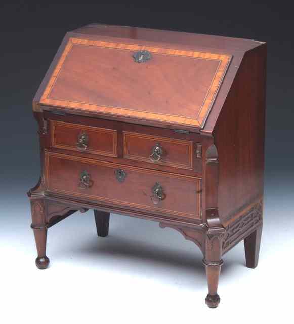 Appraisal: AN EDWARDIAN MAHOGANY AND SATINWOOD CROSSBANDED MINIATURE BUREAU having a