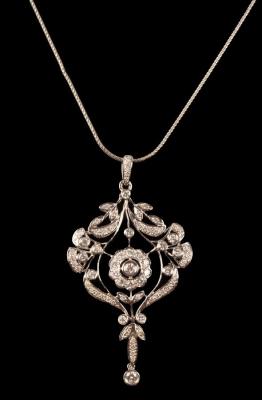 Appraisal: A diamond pendant of openwork form centred by a flowerhead