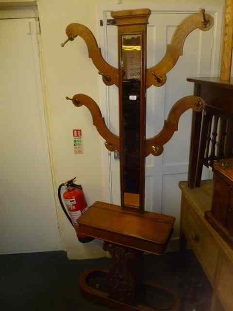 Appraisal: A VICTORIAN OAK HALL STAND incorporating a central mirror panel