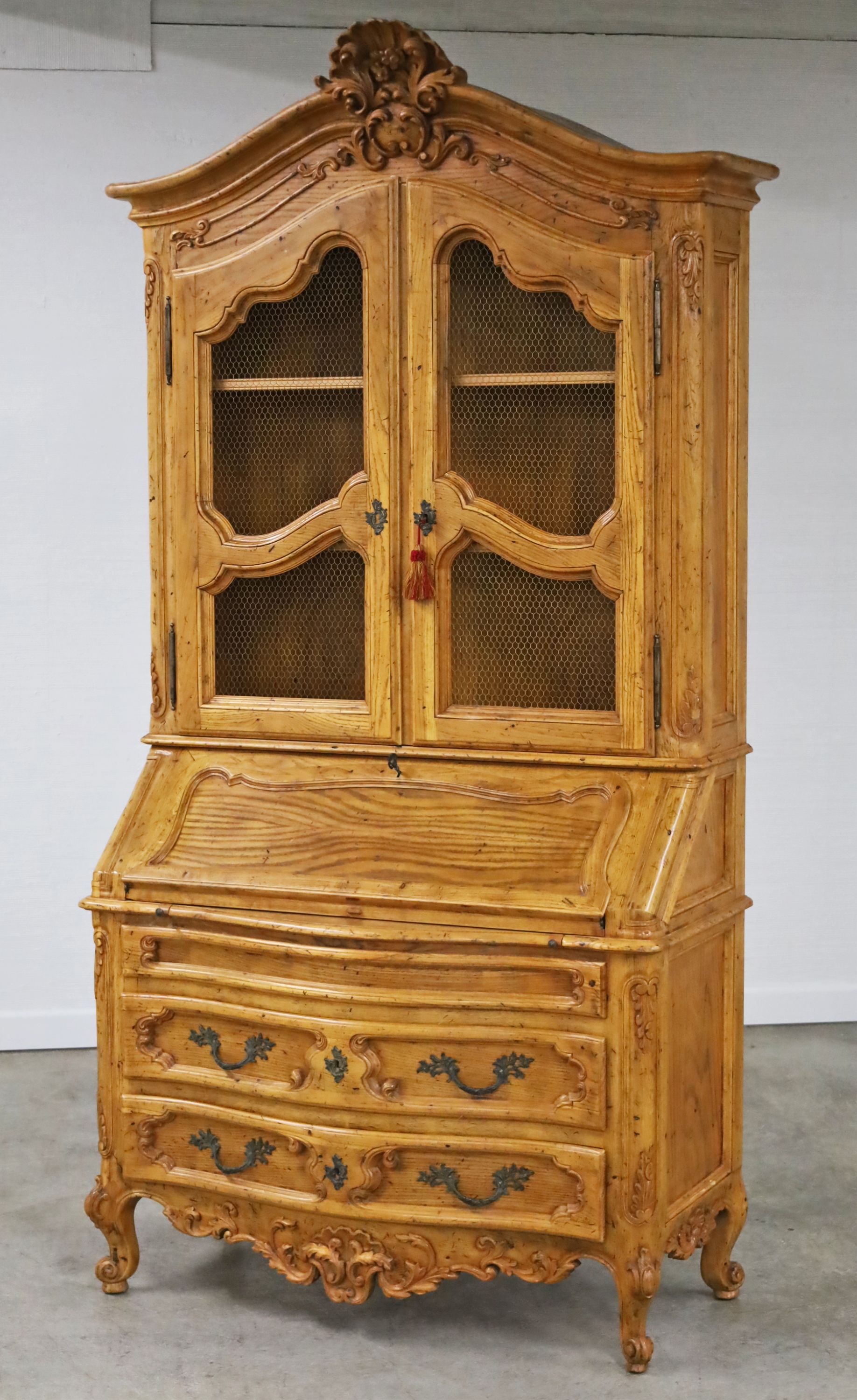 Appraisal: PROVINCIAL PINE SECRETARY Louis XV style provincial carved pine secretary