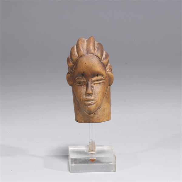 Appraisal: Carved wood West African figure head with custom lucite stand