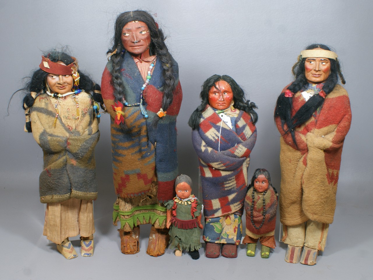 Appraisal: Skookum Dolls men a Squaw with papoose on back and