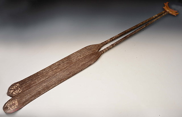 Appraisal: A PAIR OF SARAWAK BELIAN WOOD CEREMONIAL PADDLES with painted