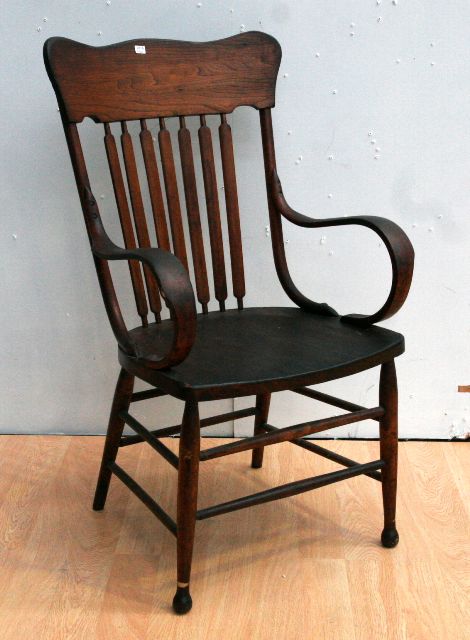 Appraisal: A stained pine armchair in the Windsor style