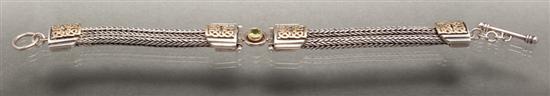 Appraisal: Silver yellow gold and peridot toggle bracelet gold unmarked signed