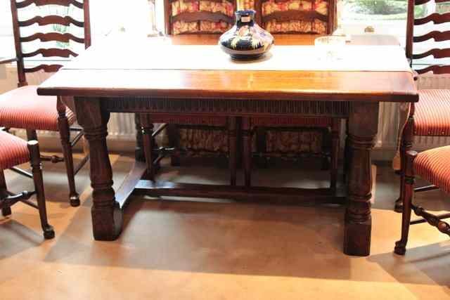 Appraisal: A TH CENTURY STYLE OAK DINING TABLE the planked top