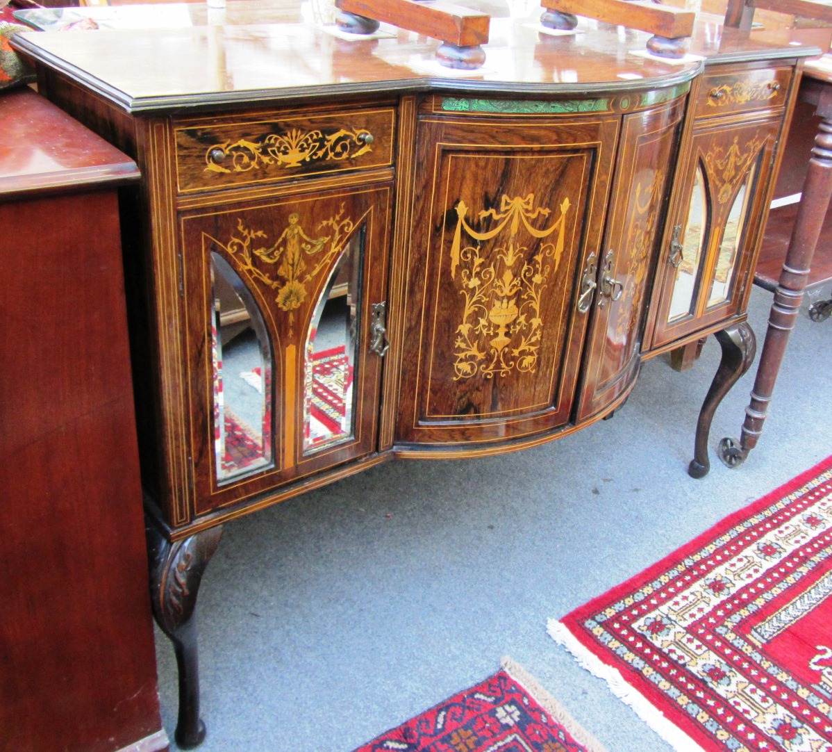 Appraisal: An Edwardian marquetry inlaid rosewood bow front side cabinet on