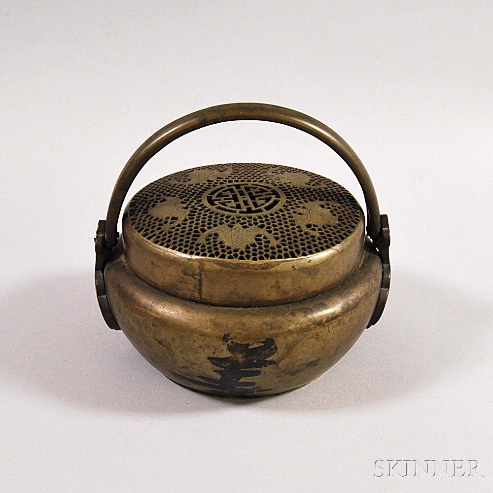 Appraisal: Bronze Hand Warmer China decorated with openwork bats and stylized