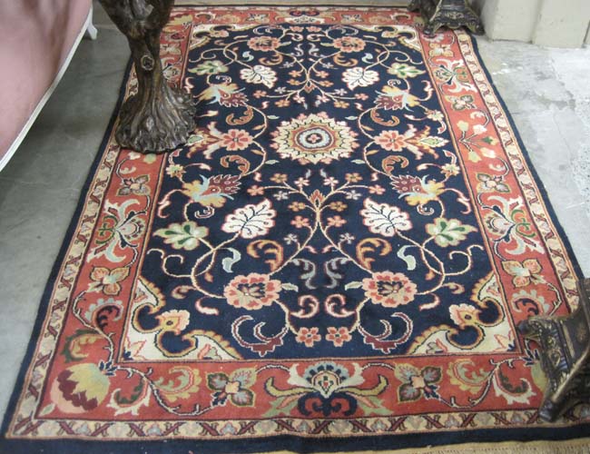 Appraisal: HAND KNOTTED ORIENTAL CARPET Pakistani-Persian overall stylized color floral design