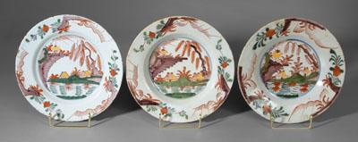 Appraisal: Three polychrome Delft plates similar scenes with trees and structures