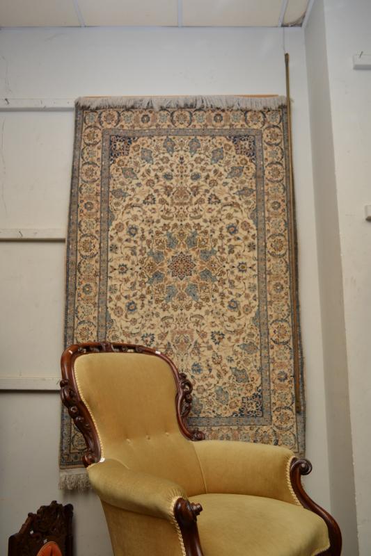 Appraisal: A PERSIAN CARPET WALL HANGING IN CREAM AND BLUE PATTERNS