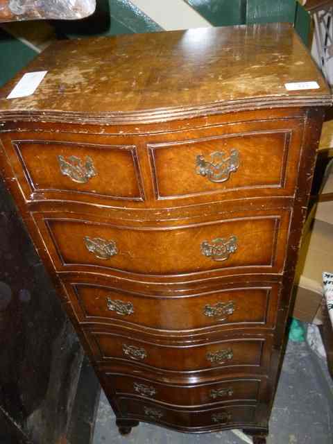 Appraisal: A REPRODUCTION WALNUT SERPENTINE TALL NARROW CHEST of six drawers