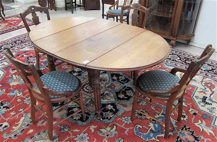 Appraisal: A VICTORIAN WALNUT DINING TABLE AND CHAIR GROUP American last