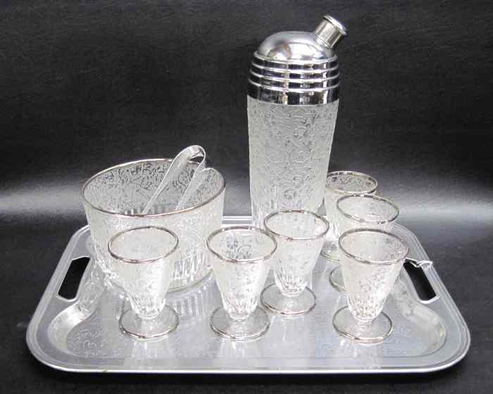 Appraisal: AMERICAN ART DECO MARTINI-COCKTAIL SET silvered open handled tray etched