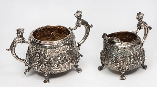 Appraisal: AN EARLY VICTORIAN CHASED AND ENGRAVED TWIN HANDLED SUGAR BOWL