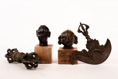 Appraisal: Two small Tibetan bronze heads a Tibetan dorje or vajra