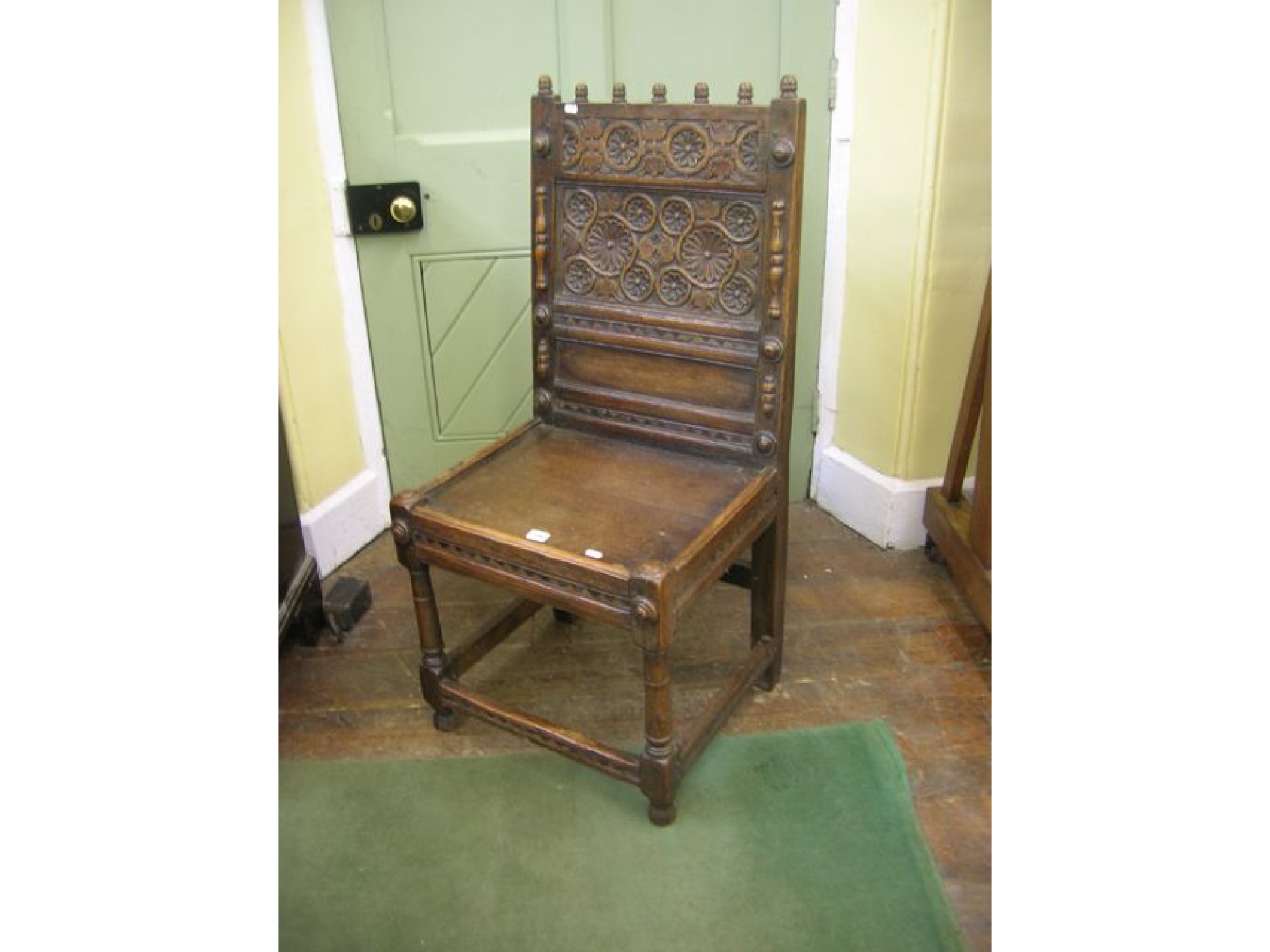 Appraisal: An old English oak side chair with carved panelled back