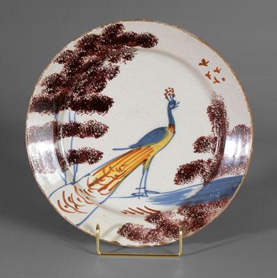 Appraisal: Delft peacock plate standing peacock between sponged manganese trees birds