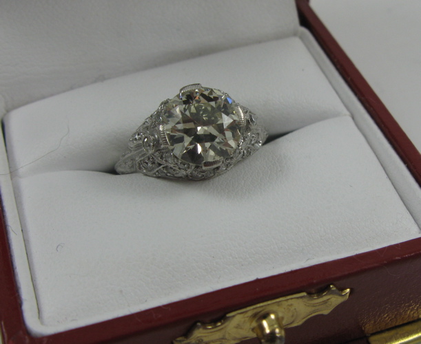 Appraisal: ESTATE DIAMOND RING with platinum setting featuring a large round-cut