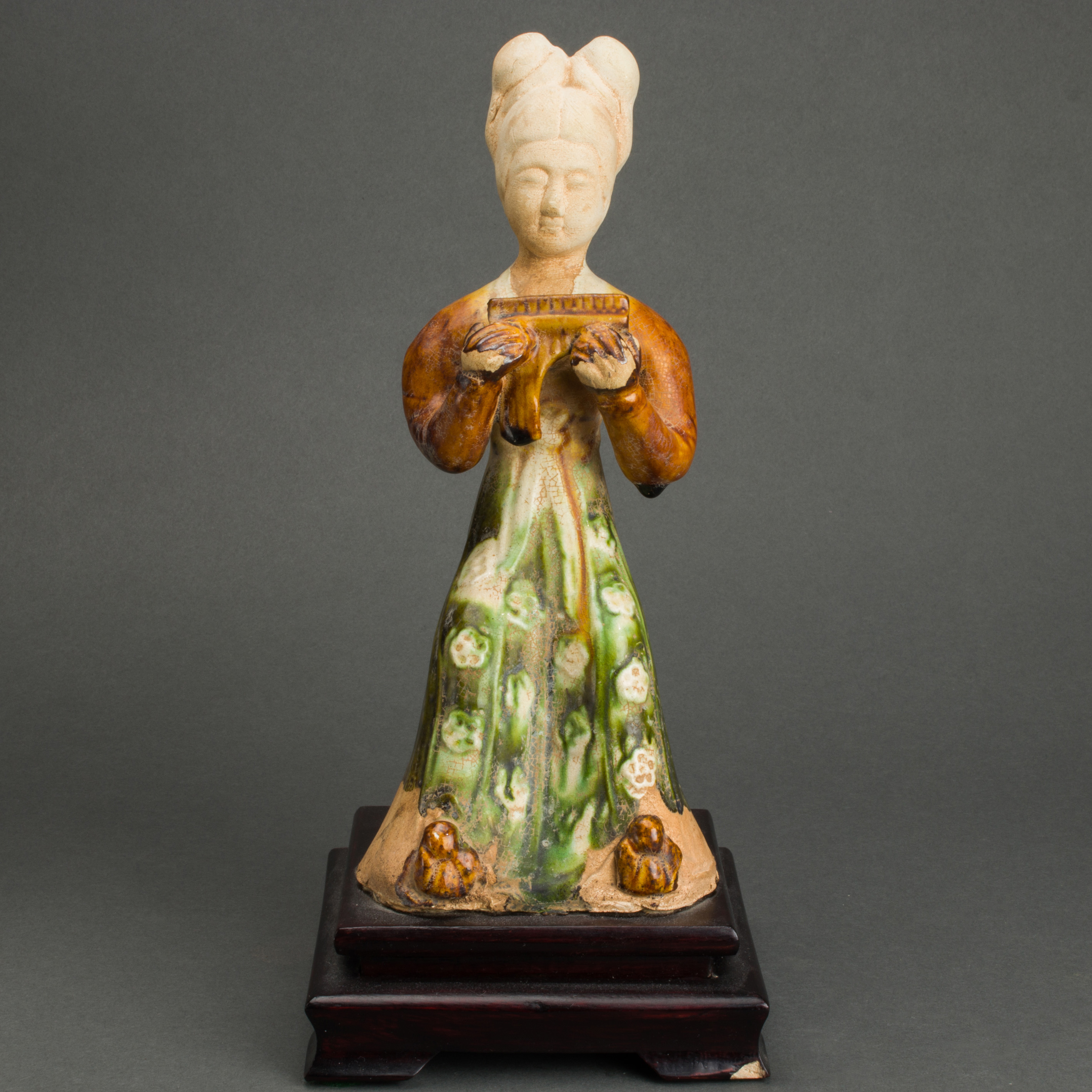 Appraisal: CHINESE TANG DYNASTY SANCAI GLAZED MUSICIAN FIGURE Chinese Tang dynasty