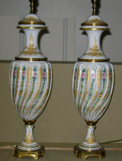 Appraisal: PAIR OF FRENCH PORCELAIN URNS AS LAMPS Sevres style white