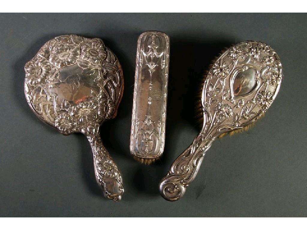 Appraisal: EDWARDIAN VII EMBOSSED SILVER HAND MIRROR with circular bevel edged