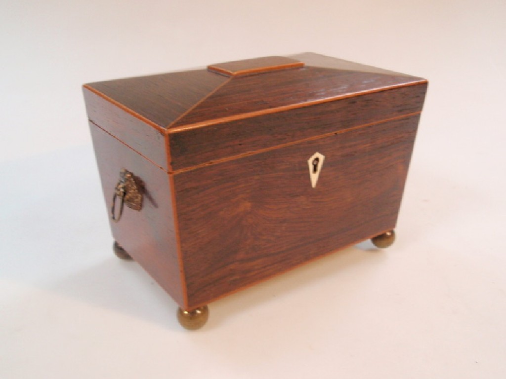 Appraisal: A Regency rosewood tea caddy of sarcophagus form the interior